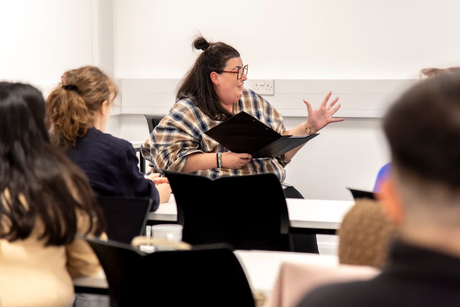 Charlie, clipboard in hand, hosting the Breaking Barriers panel at Women in Tech Week 2026
